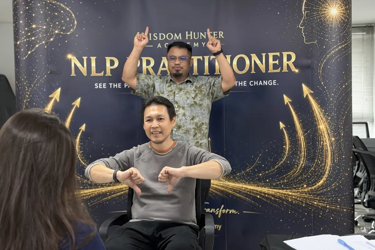 Participants practising an NLP exercise together in a bright Kuala Lumpur classroom